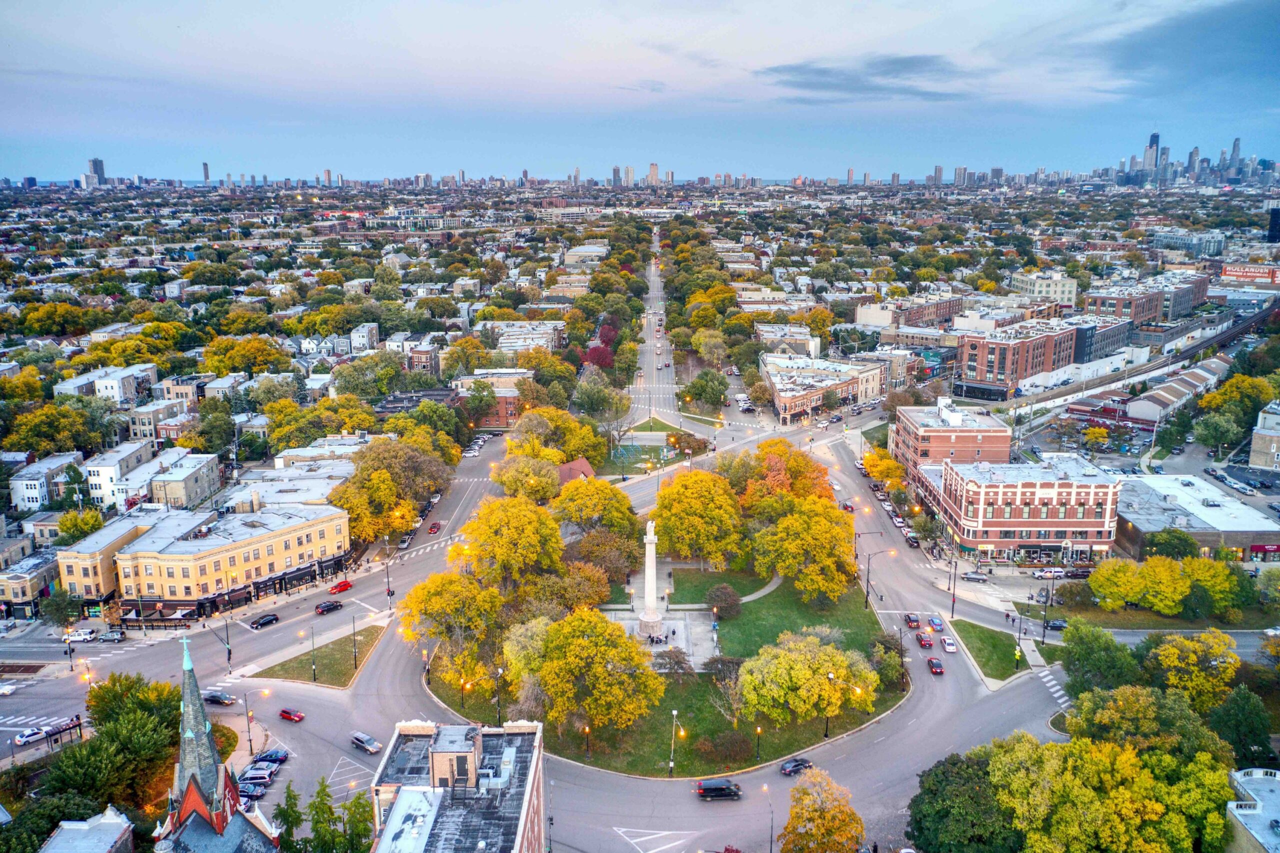 The iconic Logan Square Eagle Monument in the center of a grassy boulevard.