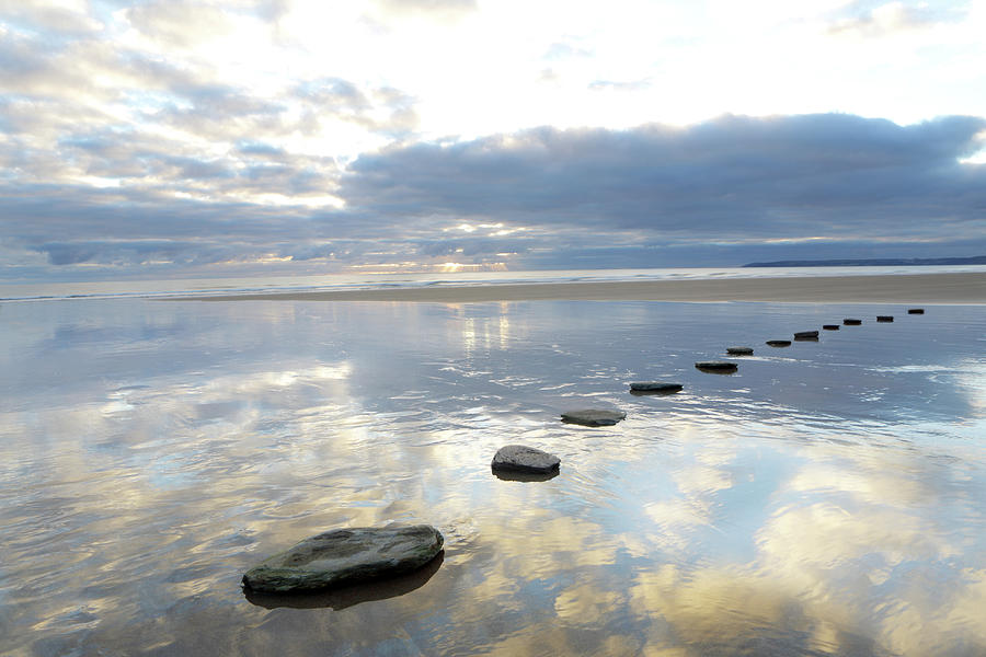 Stepping stones over water representing how obstacles become opportunities for growth through experimentation