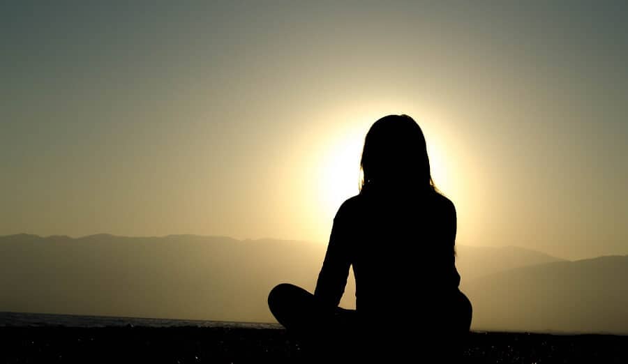 A person in peaceful contemplation, representing the mindful approach to bias for action and thoughtful experimentation