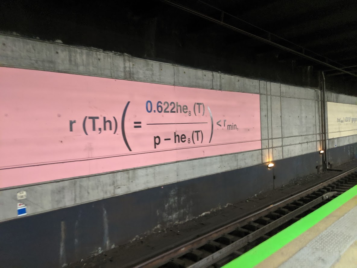 A mathematical equation mural lining the platform wall of a metro station