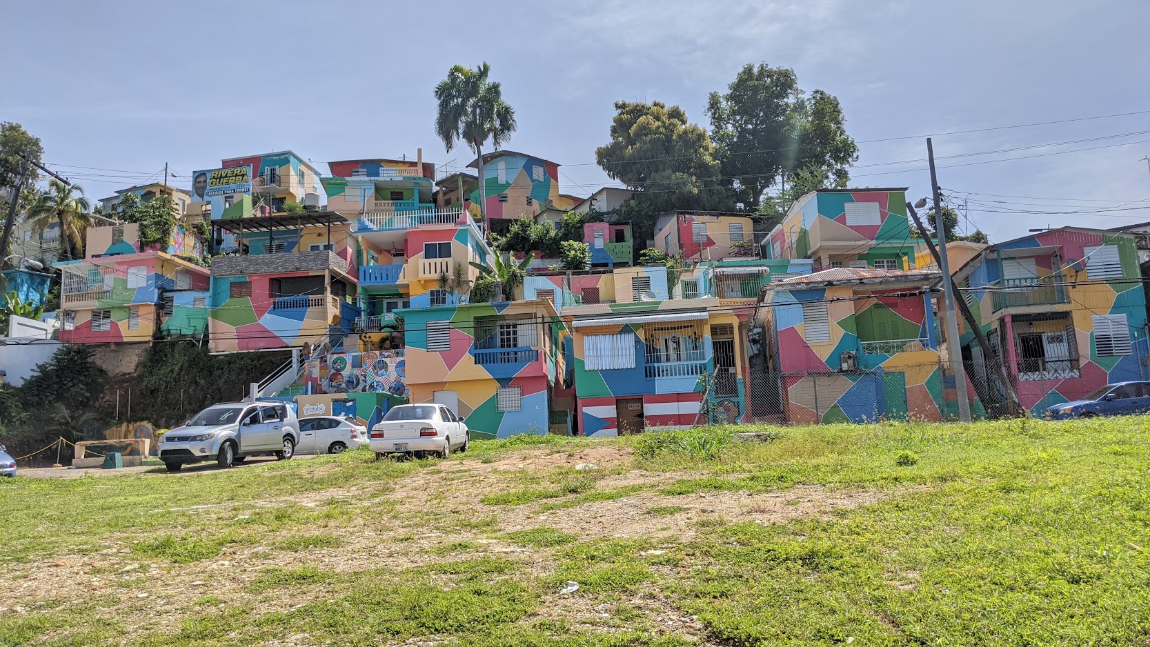 Hillside of houses painted in bright geometric blocks of color